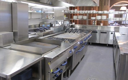 It consists commercial kitchen equipment made of 304-grade stainless steel. Includes stoves, tables, and benches for working.